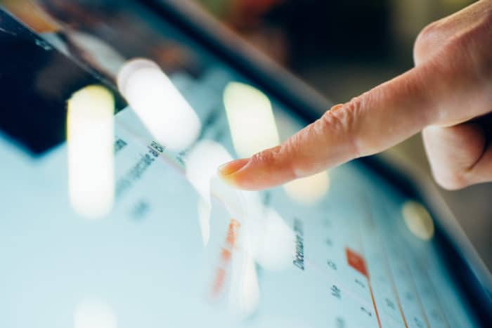 Close up on a finger touching the screen of a tablet