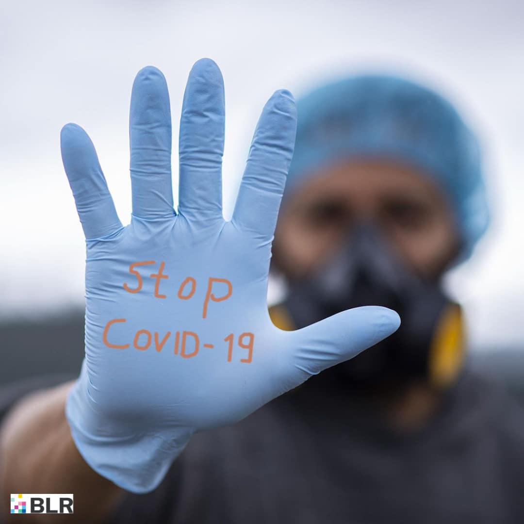 STOP COVID-19 on gloved hand