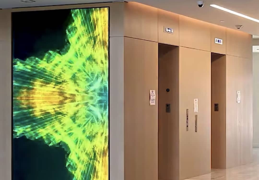 Digital signage video wall showing mixed branded content in a corporate lobby