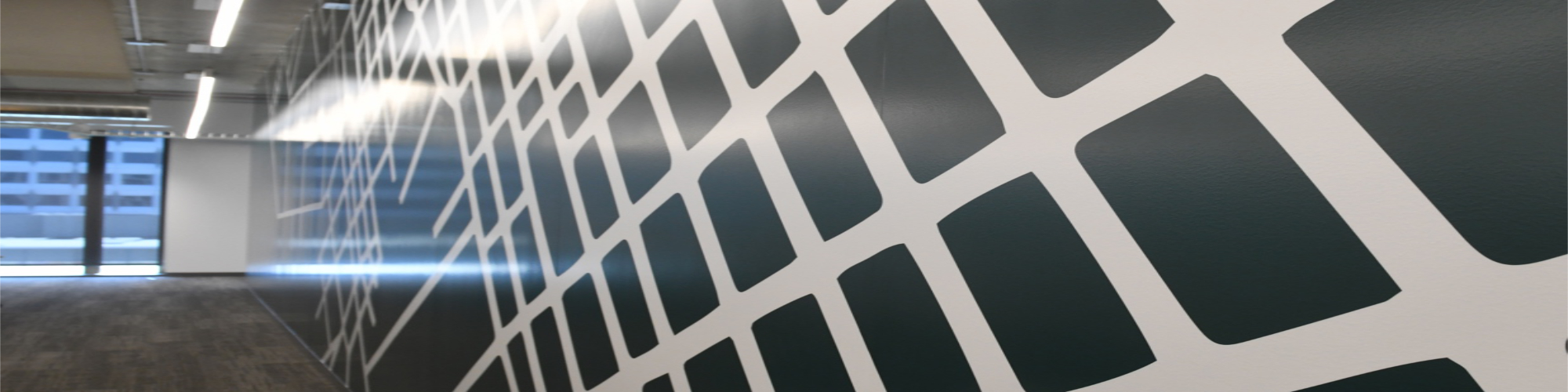 Splunk Wall Wrap_2000 Custom geometric vinyl wall graphics in corporate hallway with floor-to-ceiling windows