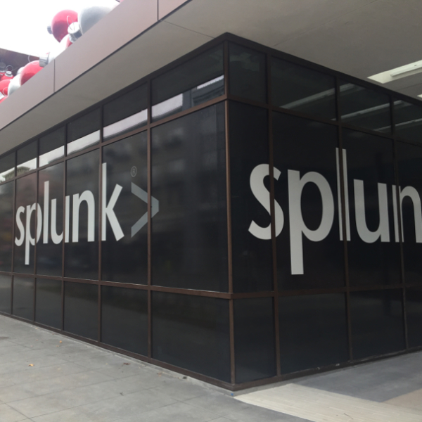 Splunk outside branding Splunk logo displayed in large white letters on the exterior glass facade of a modern office building
